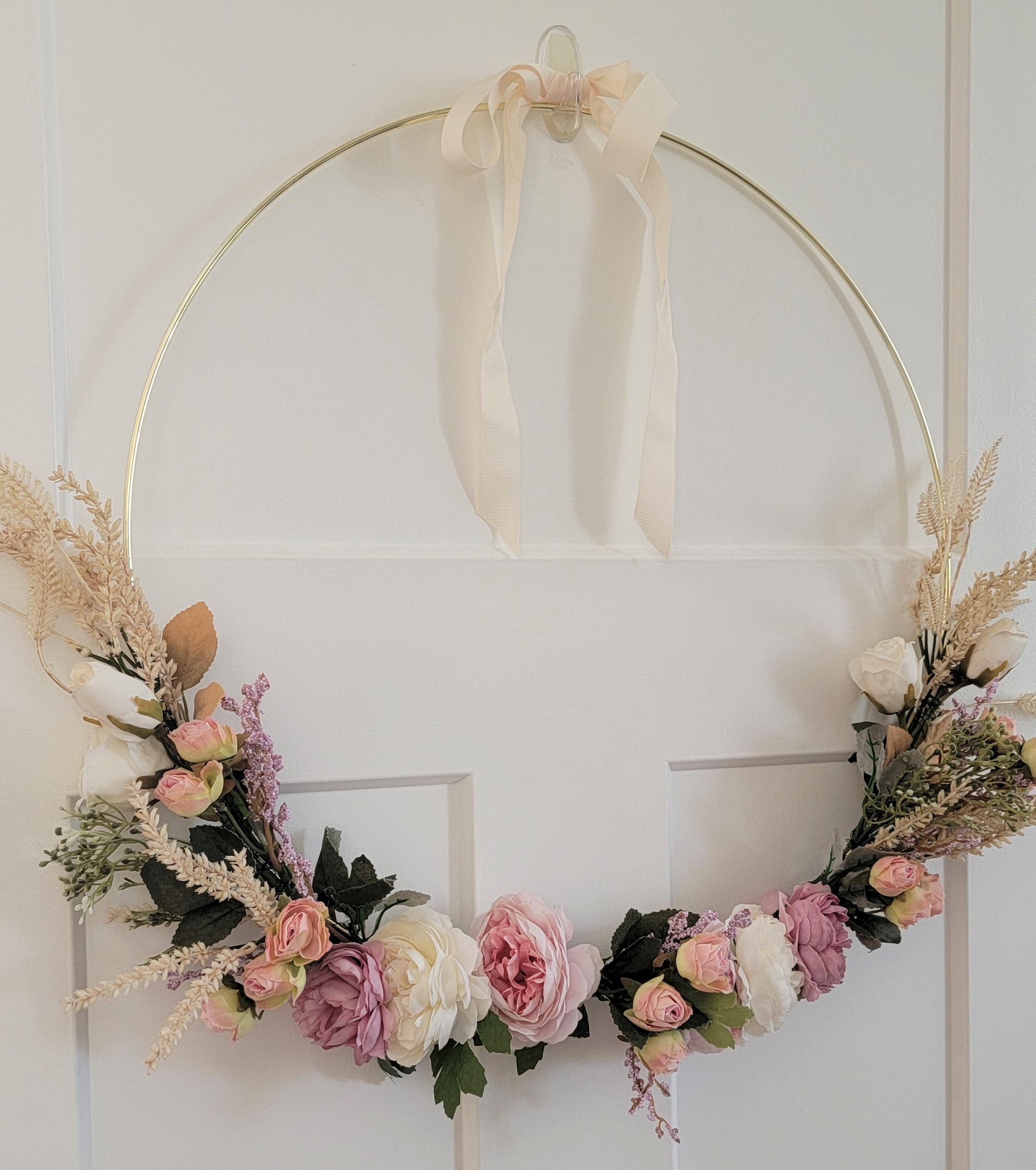 Completed DIY Floral Hoop Wreath with an extra simple ribbon over the hook